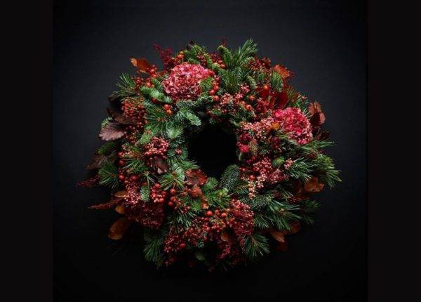 A Christmas wreath on a black background.